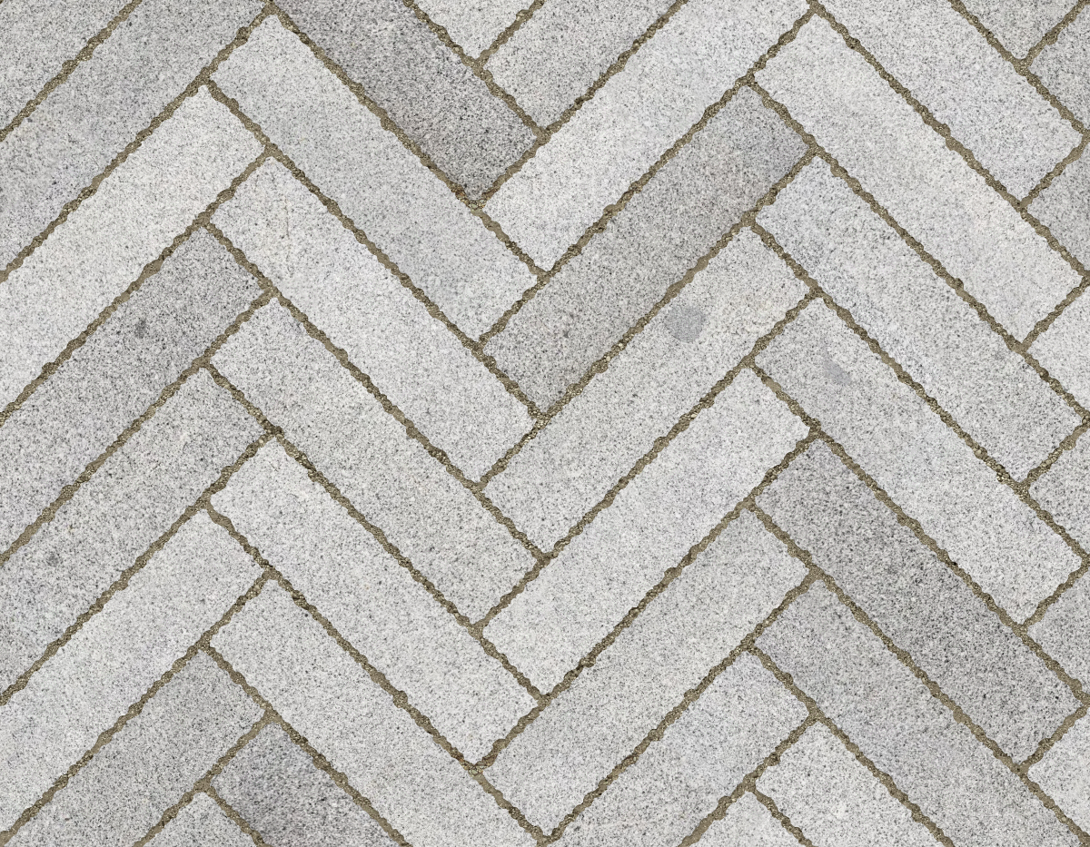 A seamless stone texture with granite blocks arranged in a Herringbone pattern