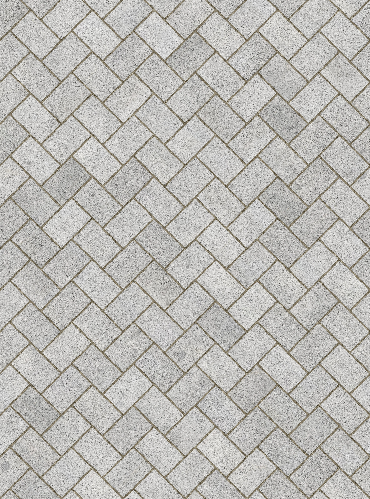A seamless stone texture with granite blocks arranged in a Herringbone pattern