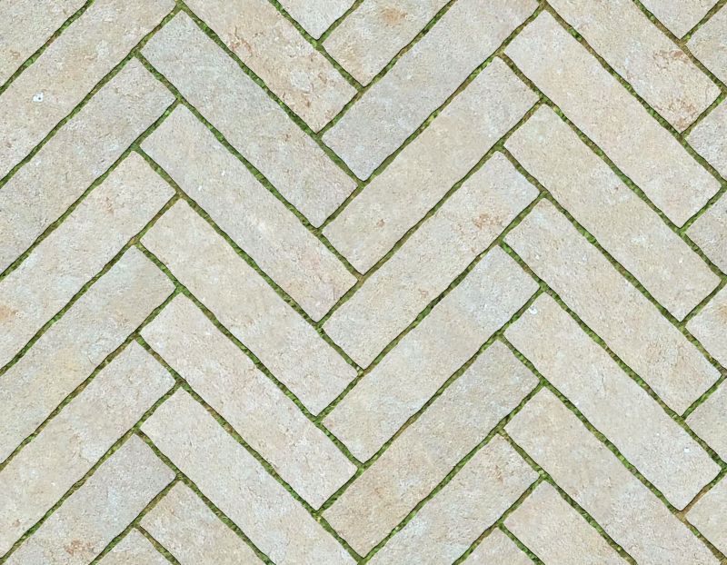 A seamless stone texture with reconstituted stone blocks arranged in a Herringbone pattern