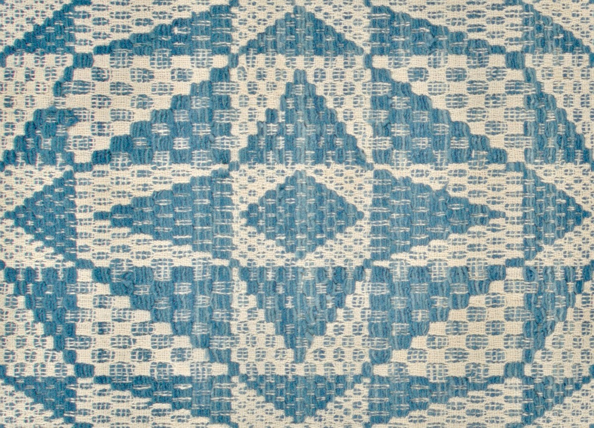 A seamless fabric texture with geometric triangle textile units arranged in a None pattern