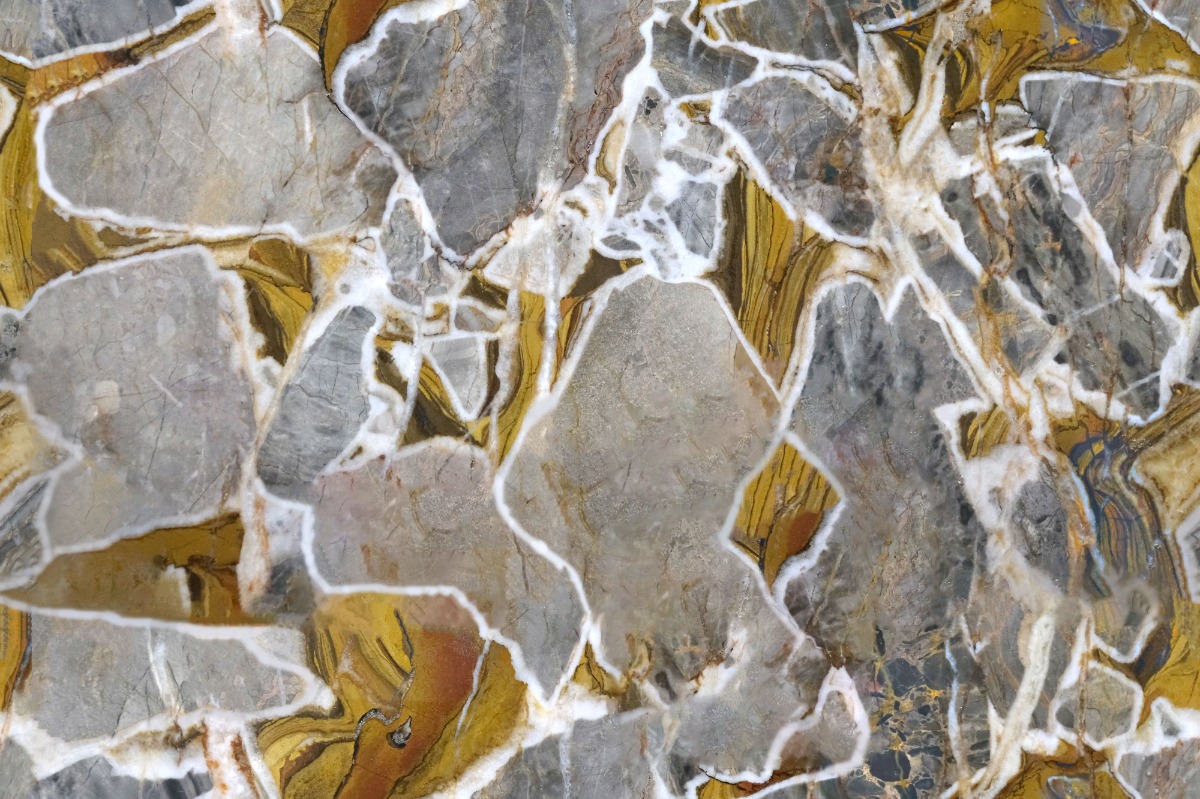 A seamless stone texture with golden grey marble blocks arranged in a None pattern