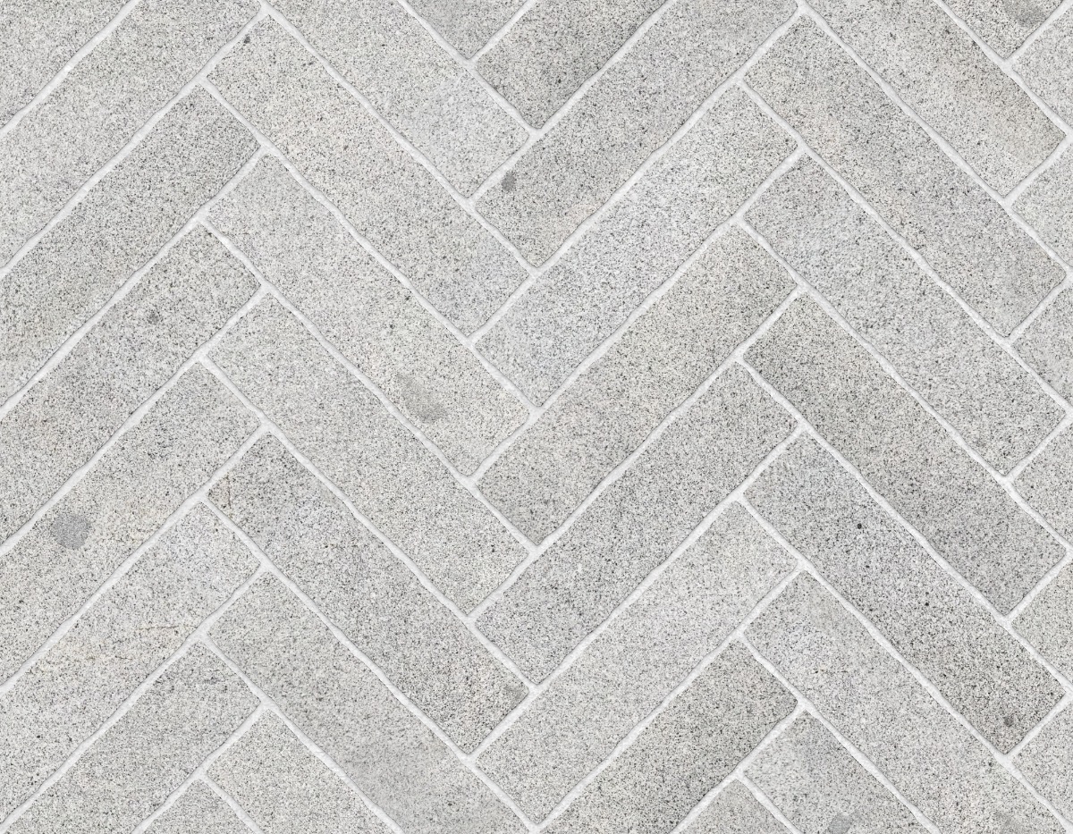 A seamless stone texture with granite blocks arranged in a Herringbone pattern