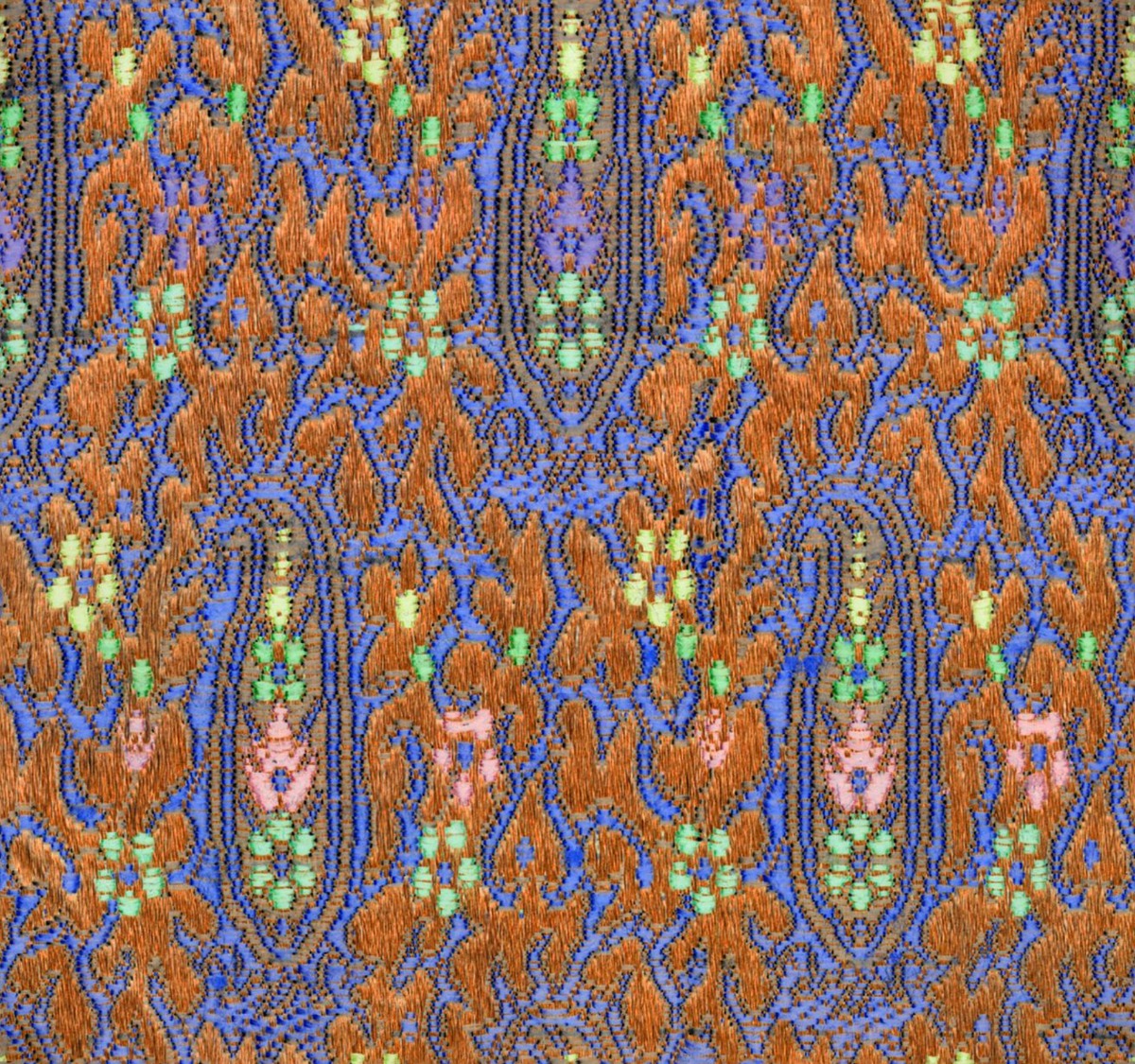 A seamless fabric texture with paisley woven silk units arranged in a None pattern