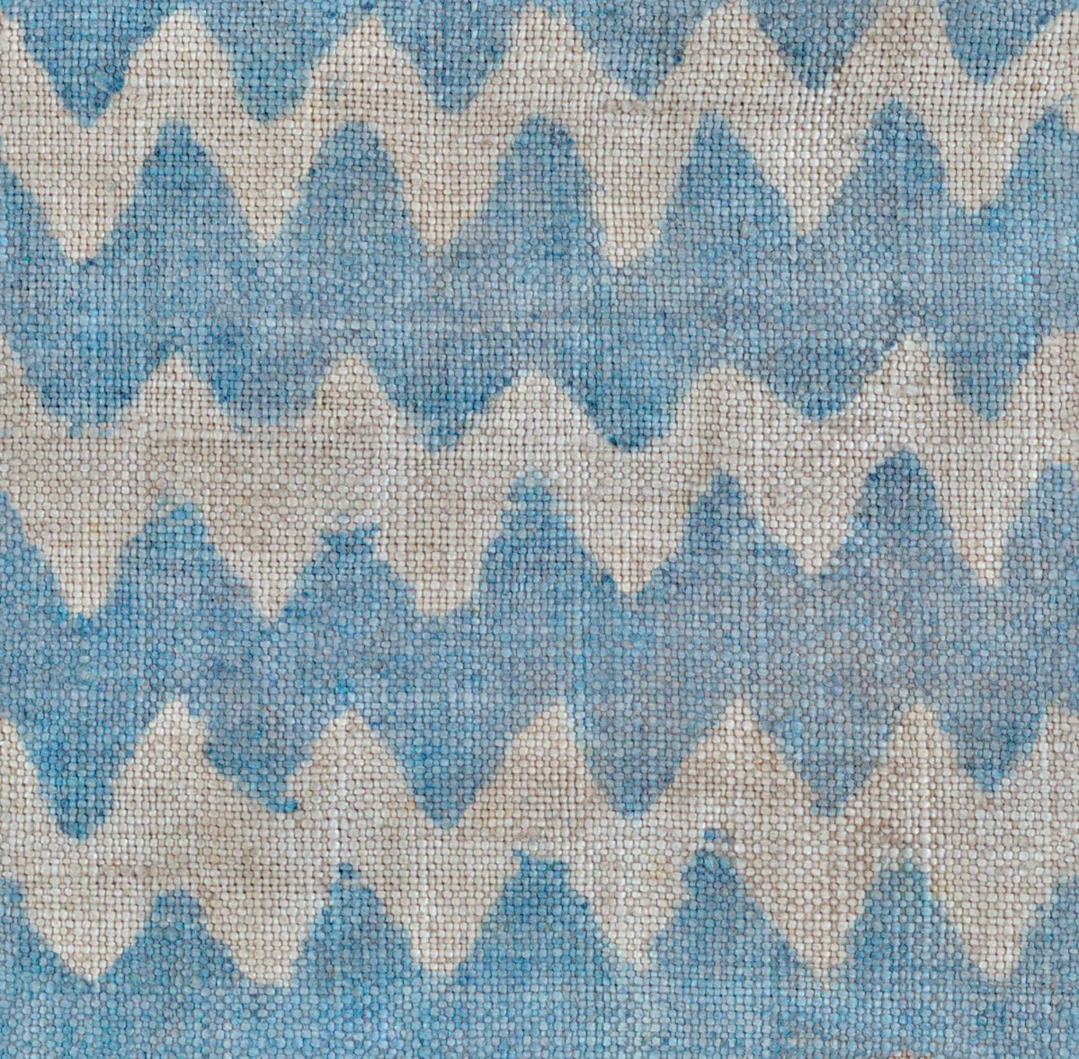 A seamless fabric texture with zig-zag textile units arranged in a None pattern