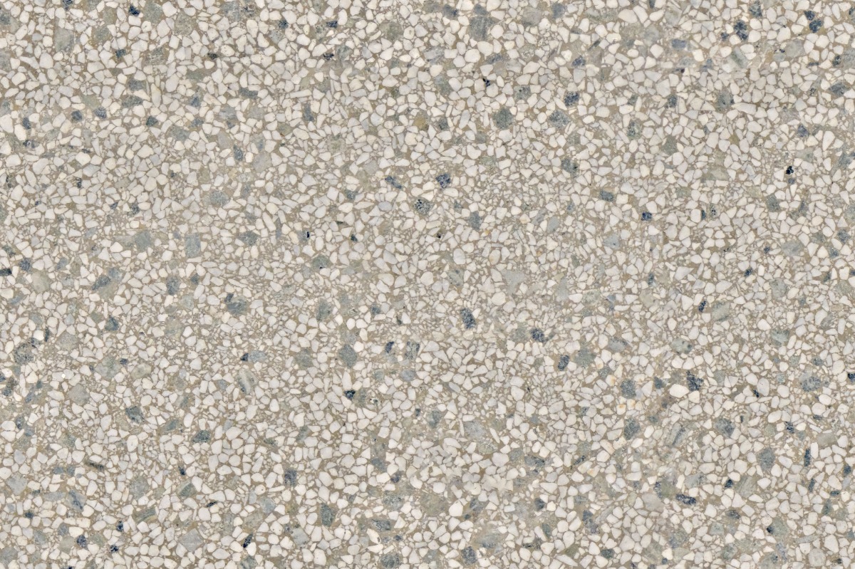 A seamless terrazzo texture with greige terrazzo units arranged in a None pattern