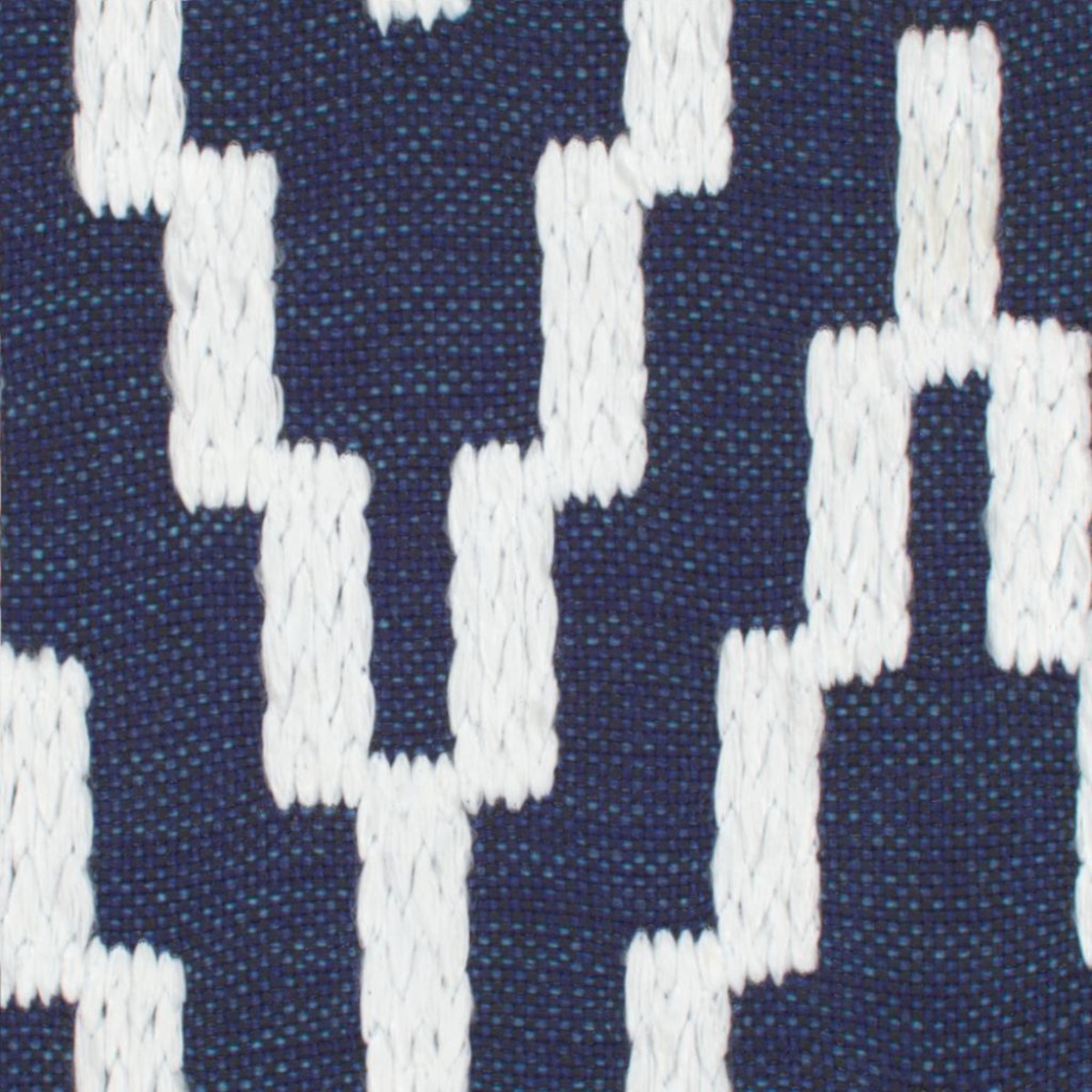 A seamless fabric texture with geometric blue embroidery units arranged in a None pattern