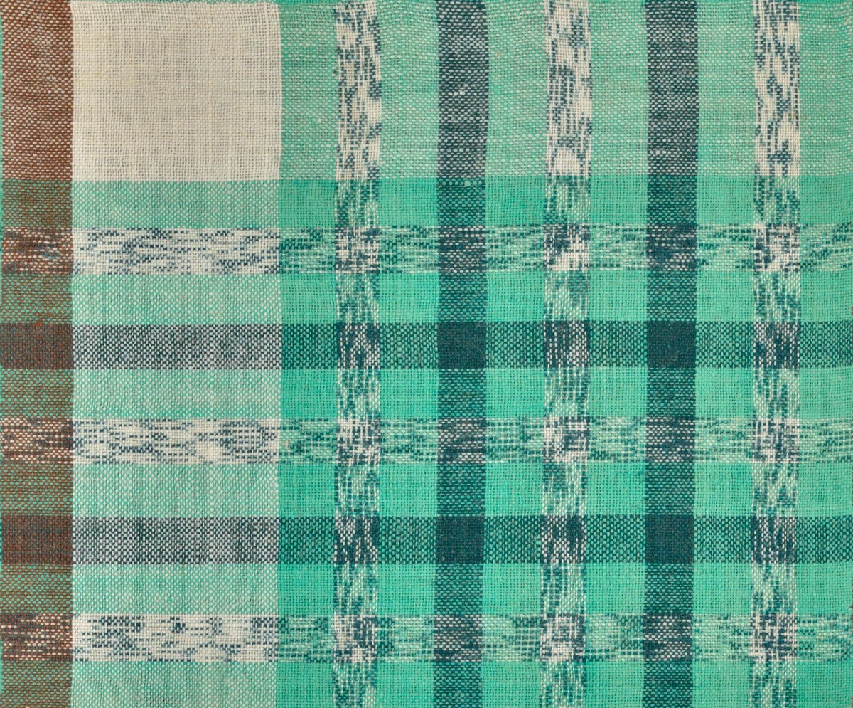 A seamless fabric texture with turquoise plaid textile units arranged in a None pattern