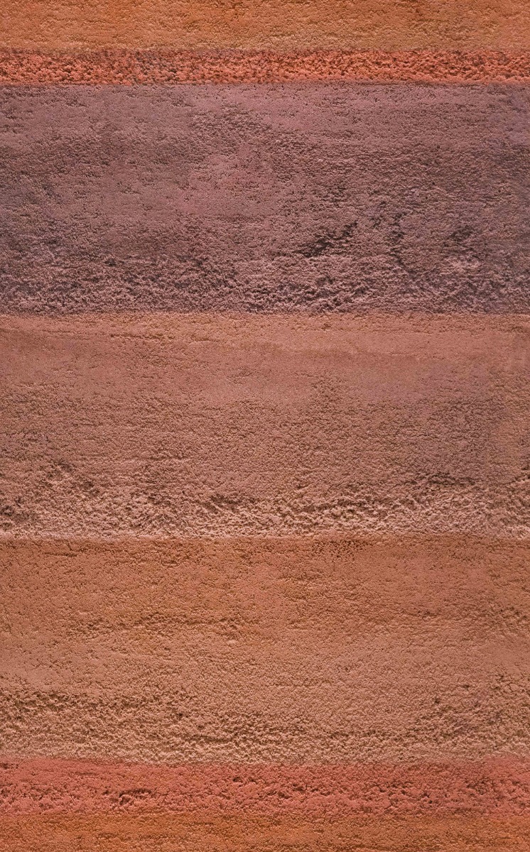 A seamless wall finishes texture with rammed earth finish units arranged in a None pattern
