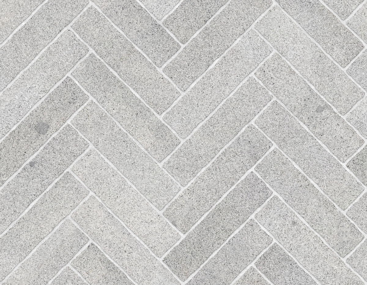 A seamless stone texture with granite blocks arranged in a Herringbone pattern