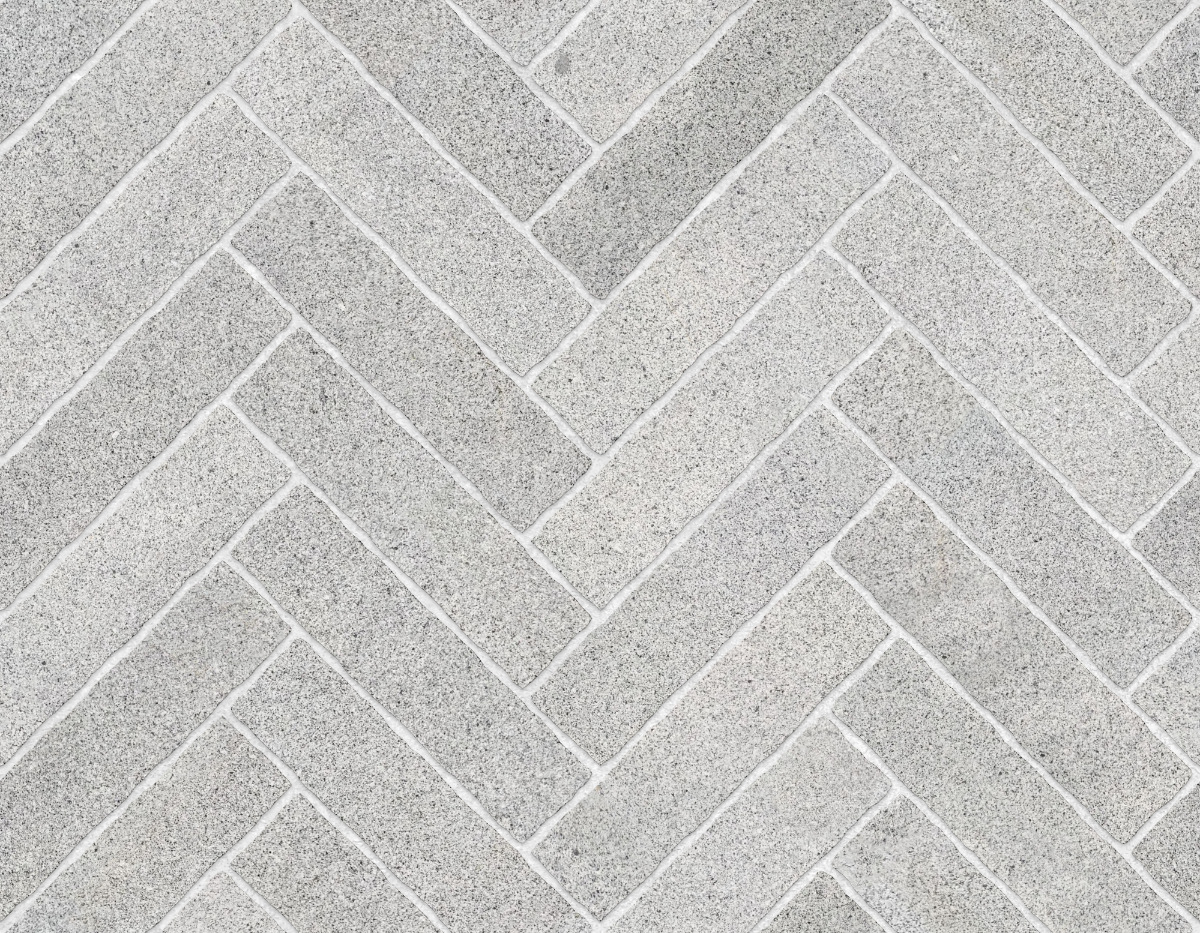 A seamless stone texture with granite blocks arranged in a Herringbone pattern