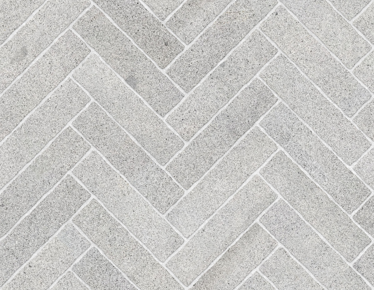 A seamless stone texture with granite blocks arranged in a Herringbone pattern