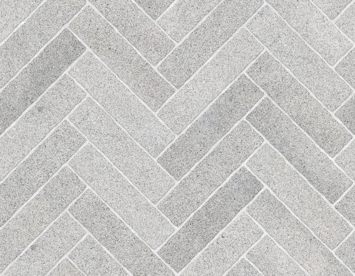 A seamless stone texture with granite blocks arranged in a Herringbone pattern