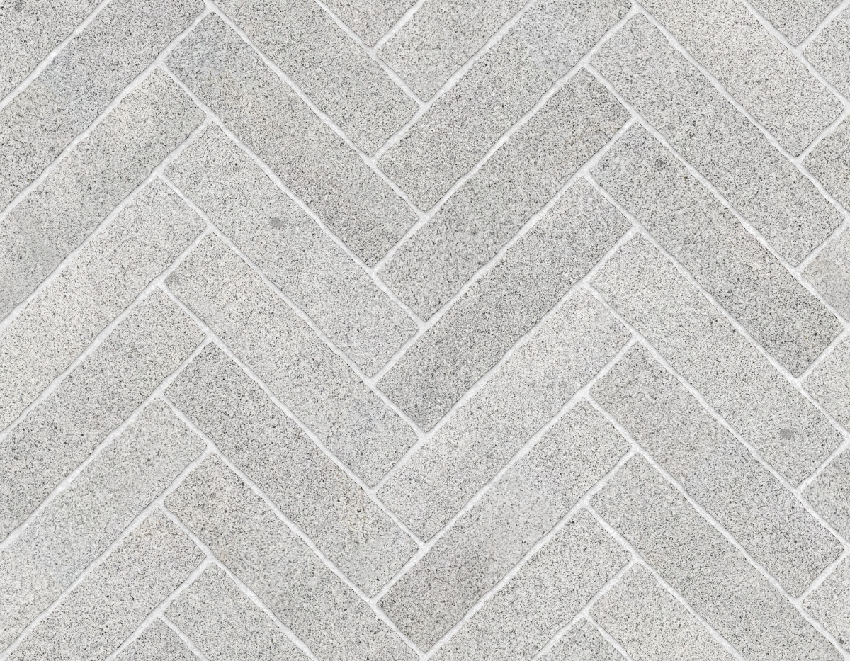 A seamless stone texture with granite blocks arranged in a Herringbone pattern