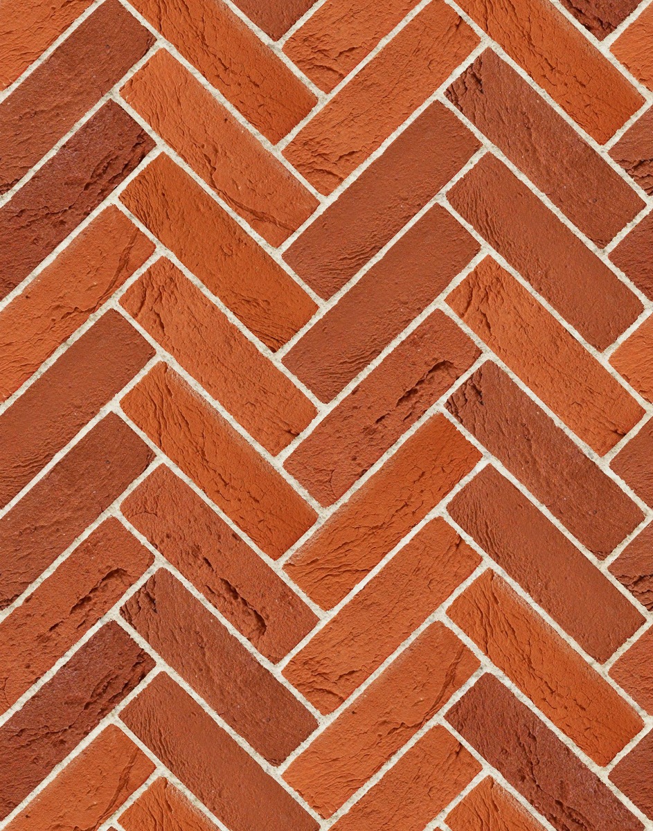 A seamless brick texture with fine handmade textured red blend units arranged in a Herringbone pattern