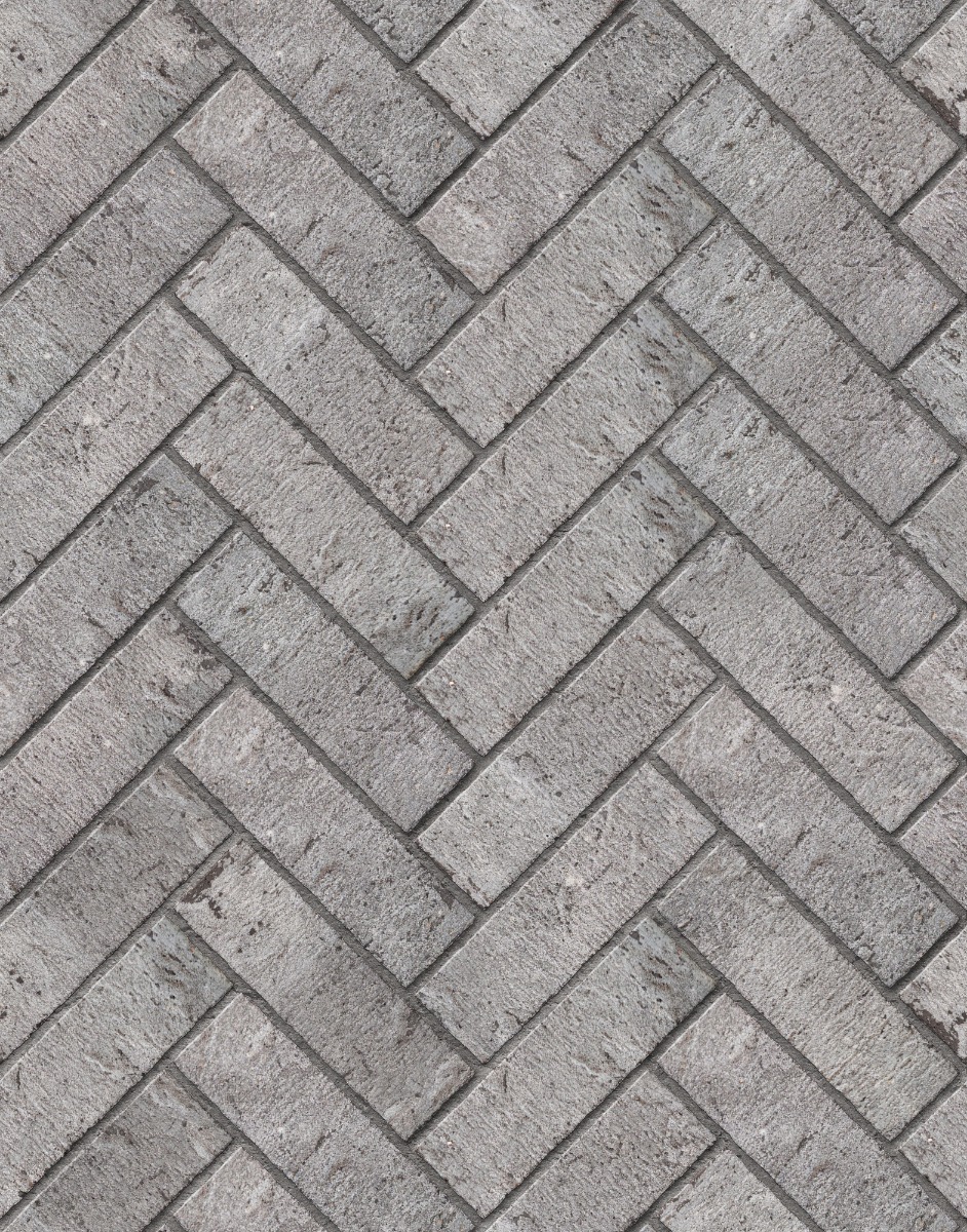 A seamless brick texture with shadow gray units arranged in a Herringbone pattern