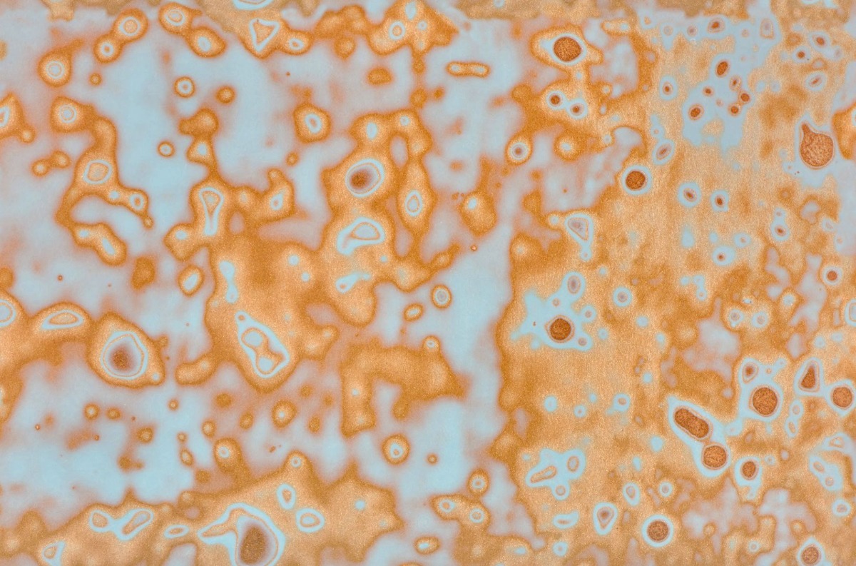 A seamless surfaces texture with copper/teal  units arranged in a None pattern