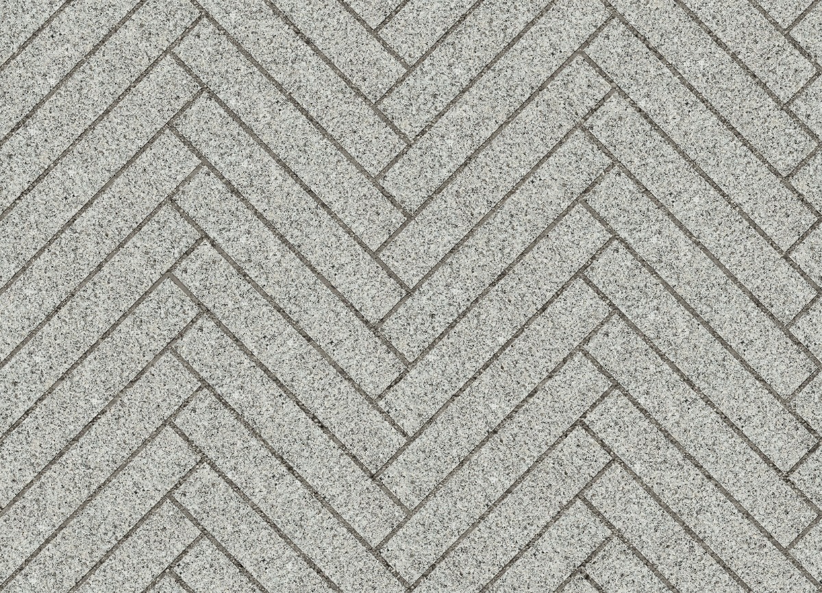 A seamless stone texture with flamed royal white granite blocks arranged in a Herringbone pattern