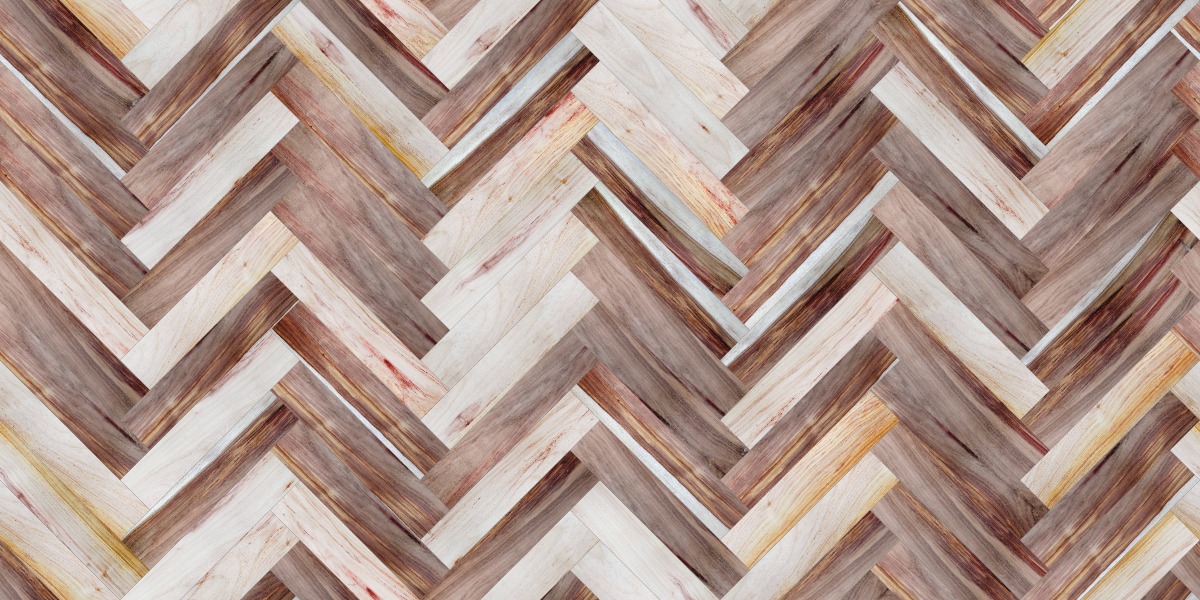 A seamless wood texture with canarywood boards arranged in a Herringbone pattern