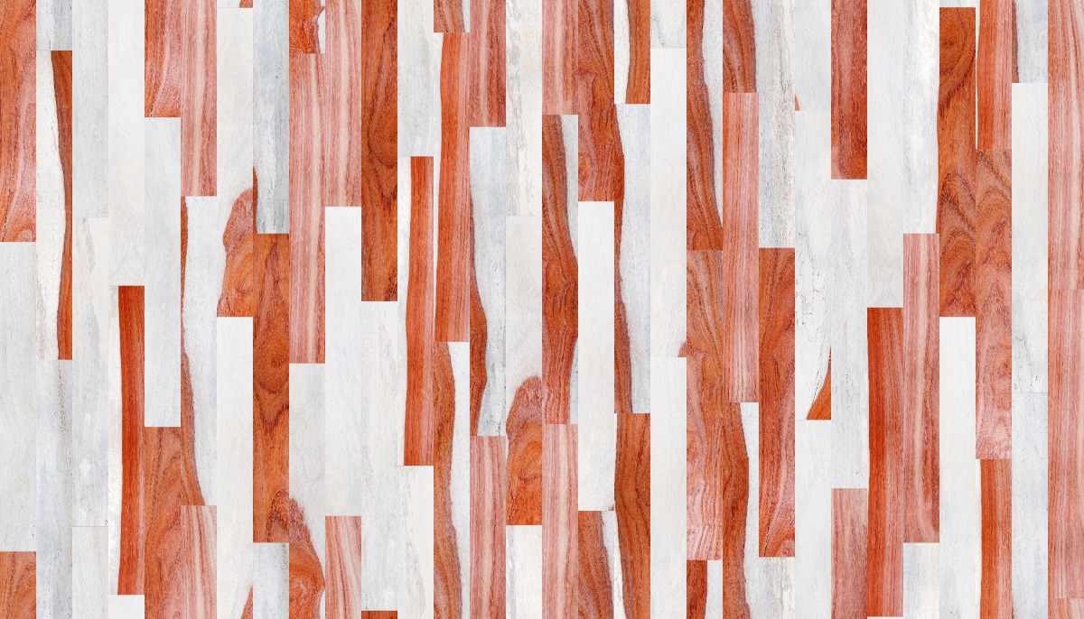 A seamless wood texture with padauk - patterned boards arranged in a Staggered pattern
