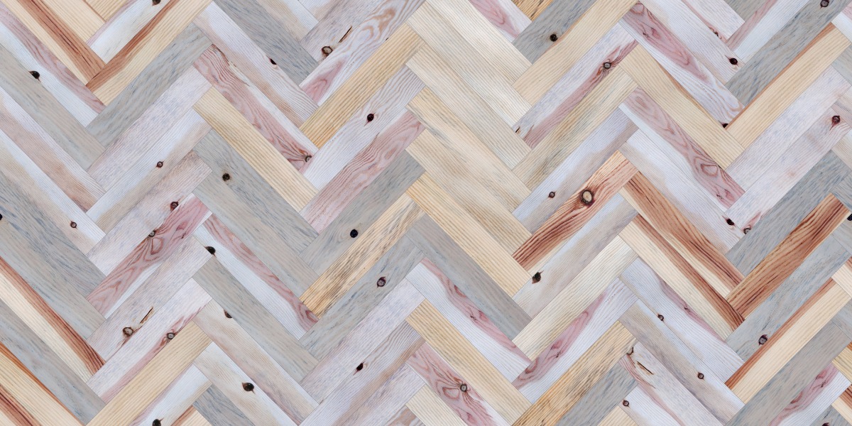 A seamless wood texture with pine boards arranged in a Herringbone pattern
