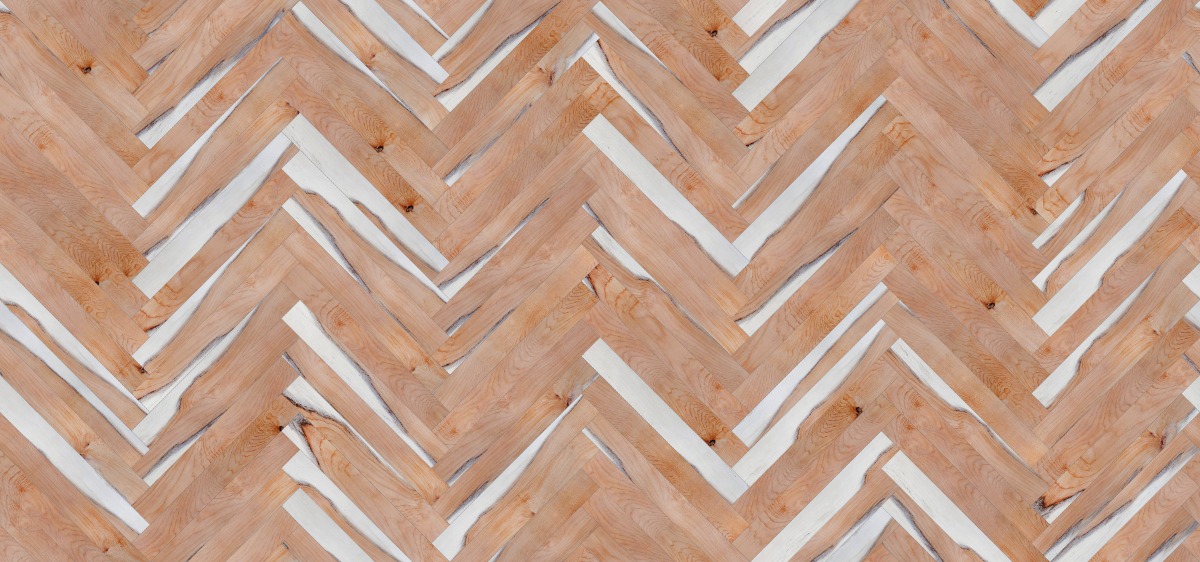 A seamless wood texture with yew boards arranged in a Herringbone pattern