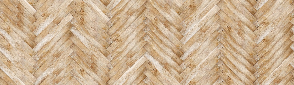 A seamless wood texture with oak hardwood flooring boards arranged in a Herringbone pattern