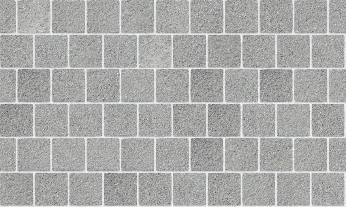 A seamless stone texture with scottish whinstone square landscaping blocks arranged in a Stretcher pattern