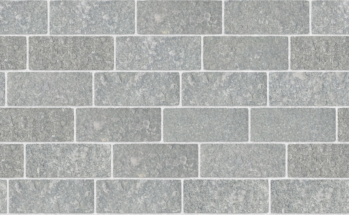 A seamless stone texture with scottish whinstone rectangular setts blocks arranged in a Staggered pattern